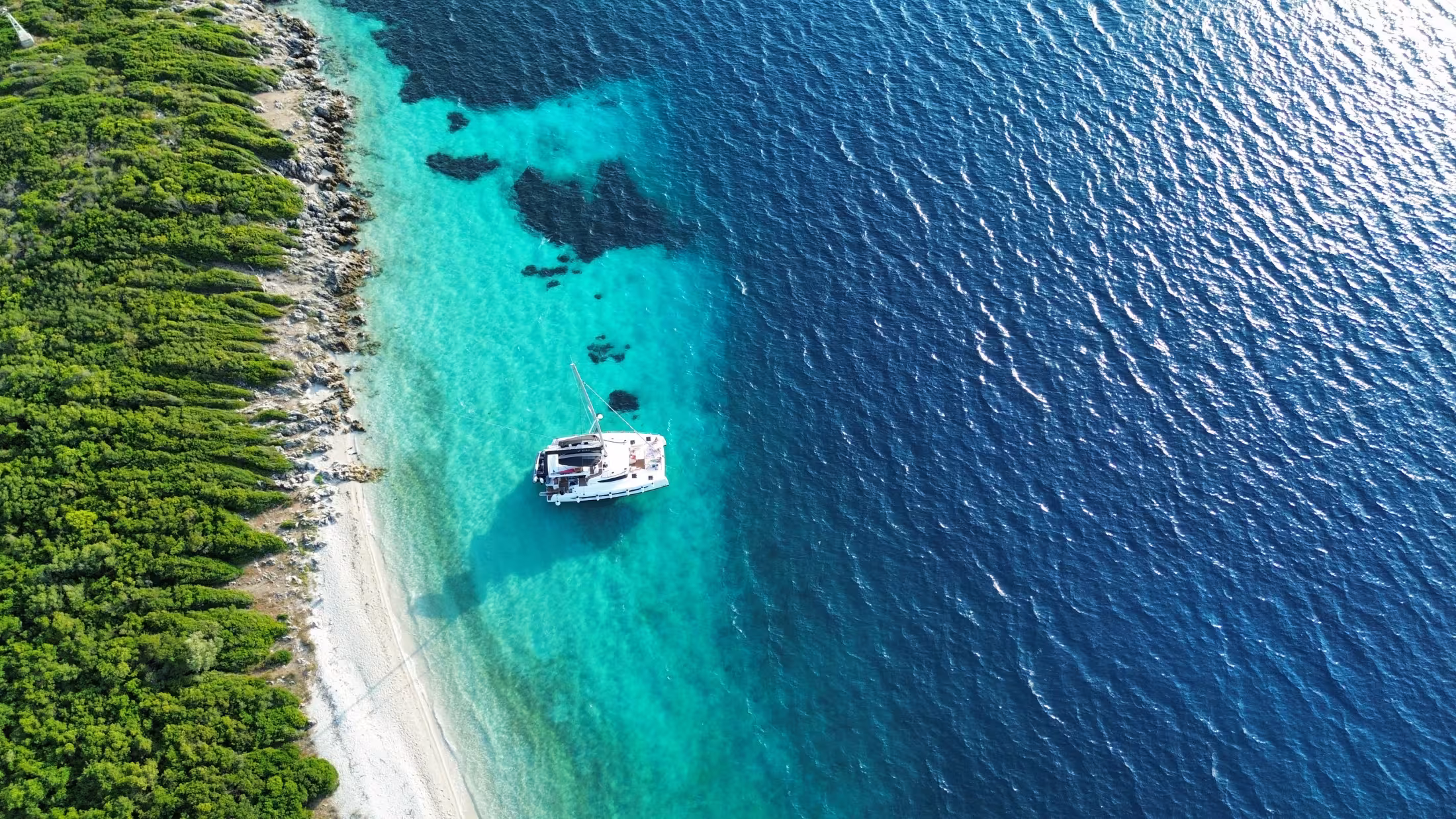 Yacht on green Ionian Sea